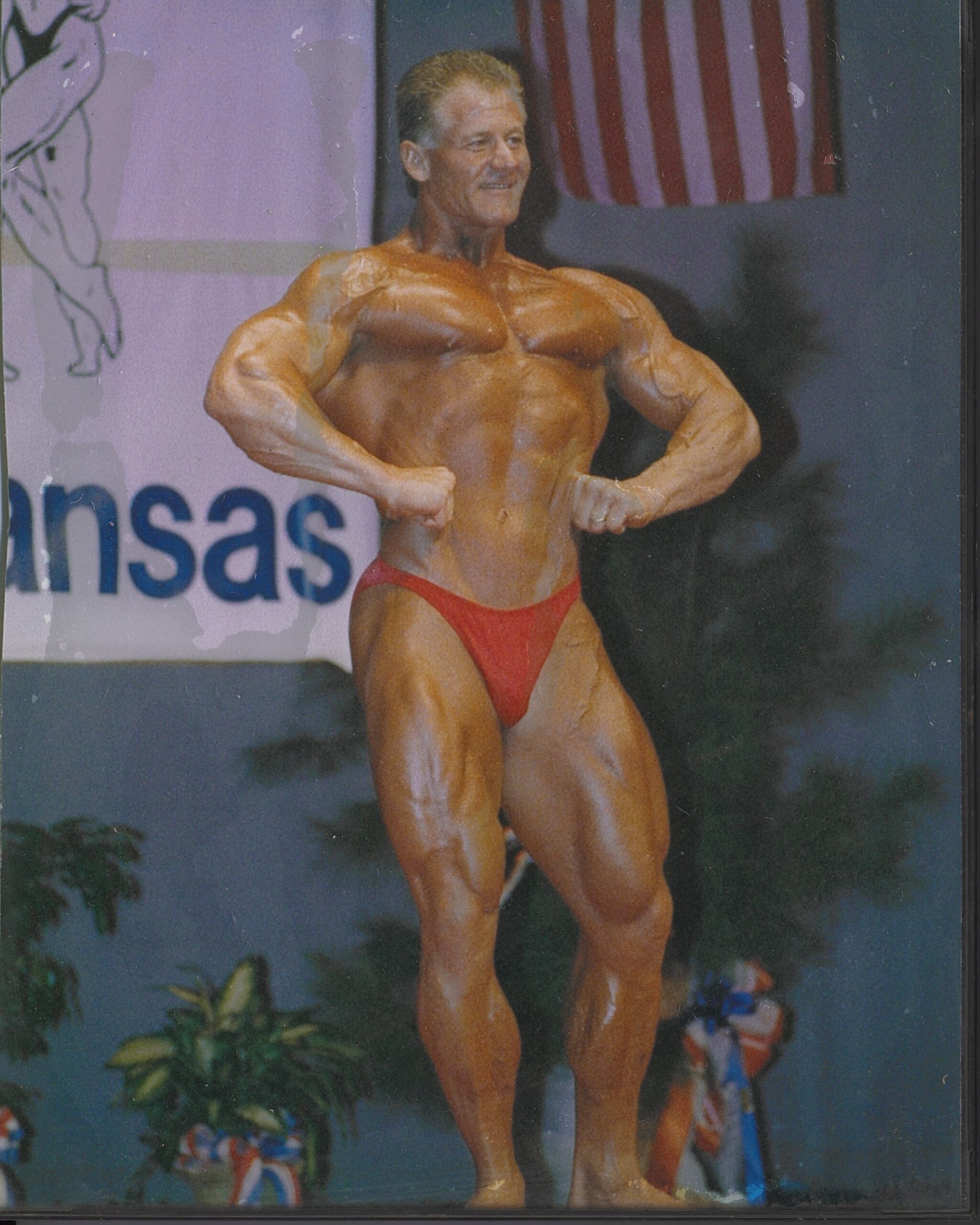 Errol Broussard posing in a bodybuilding competition.
